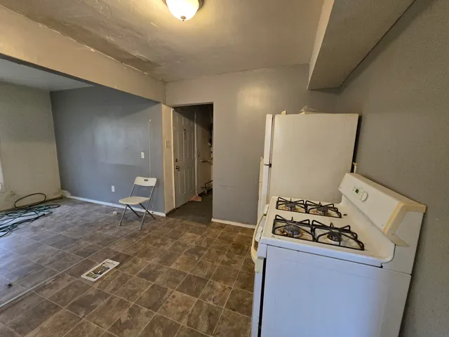 a kitchen with a sink a stove and a refrigerator