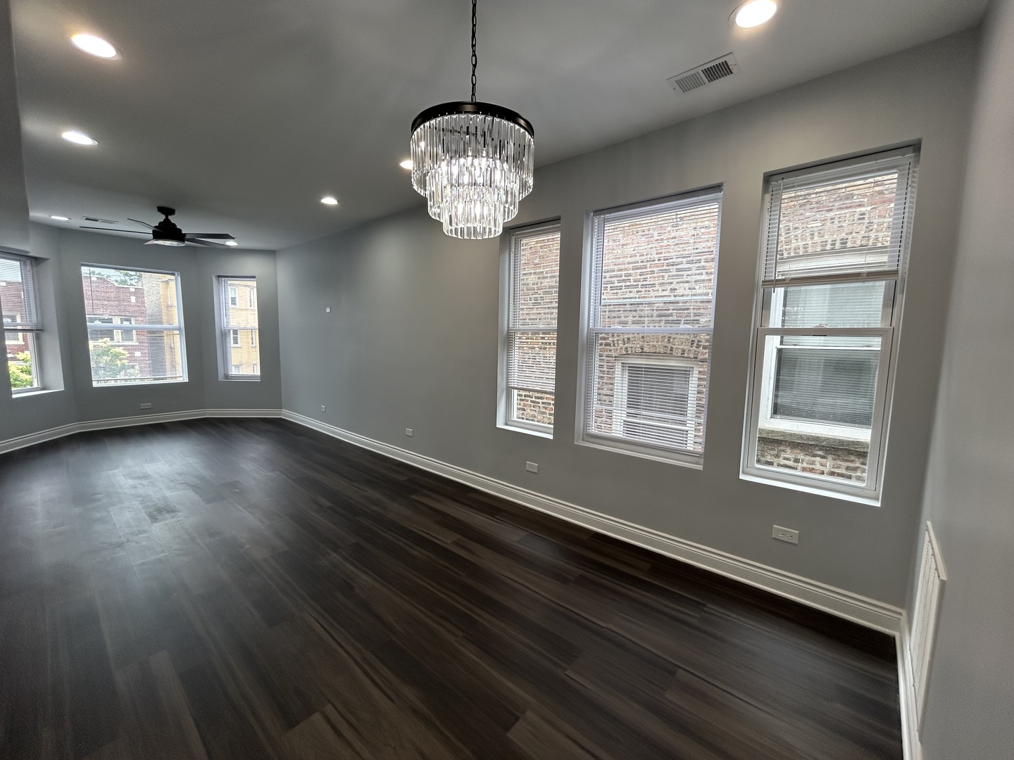 7940 South Carpenter Street, Unit 2 Chicago, IL 60620 - Photo 14 of 34 a view of an empty room with wooden floor and a window