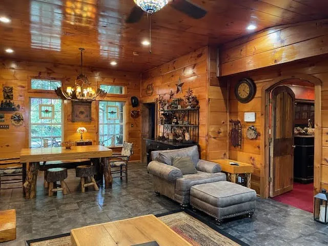 a living room with lots of furniture and chandelier
