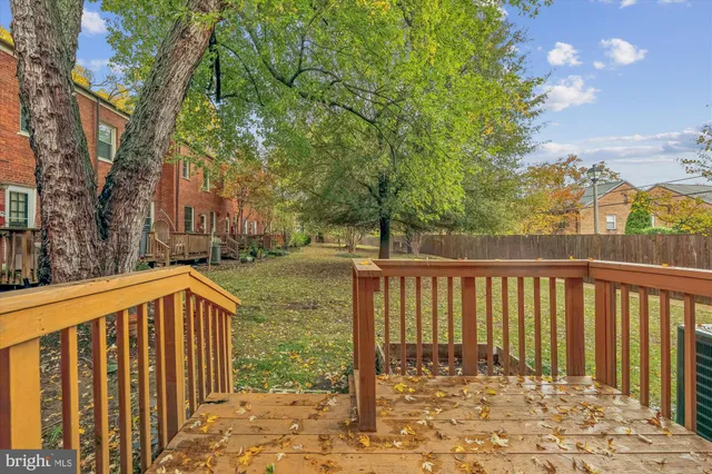 a view of a brick house with a large trees