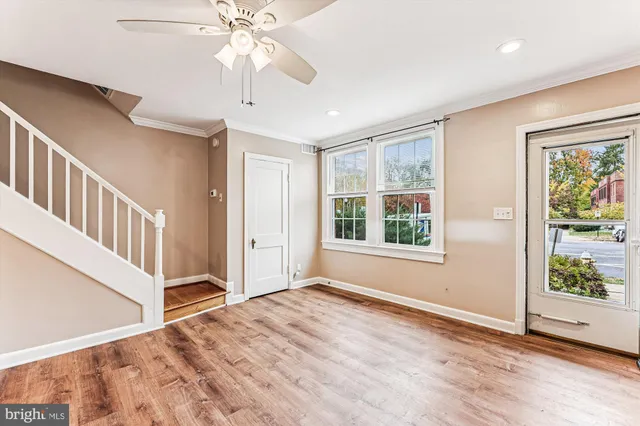 wooden floor in an empty room with a window