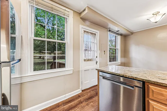 a kitchen with granite countertop a sink and a window
