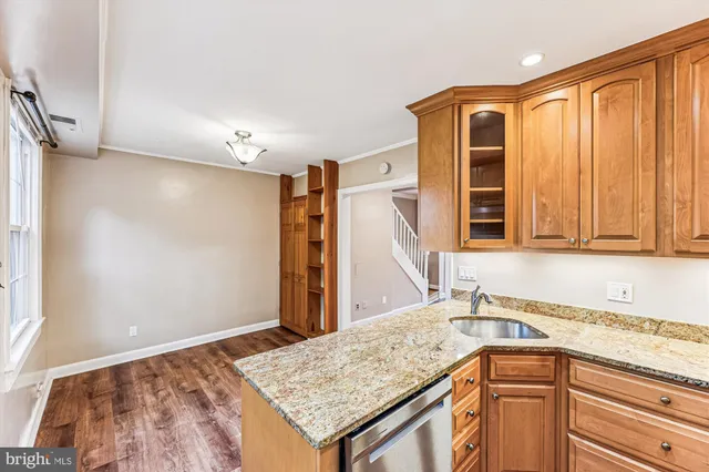 a kitchen with a sink refrigerator and cabinets