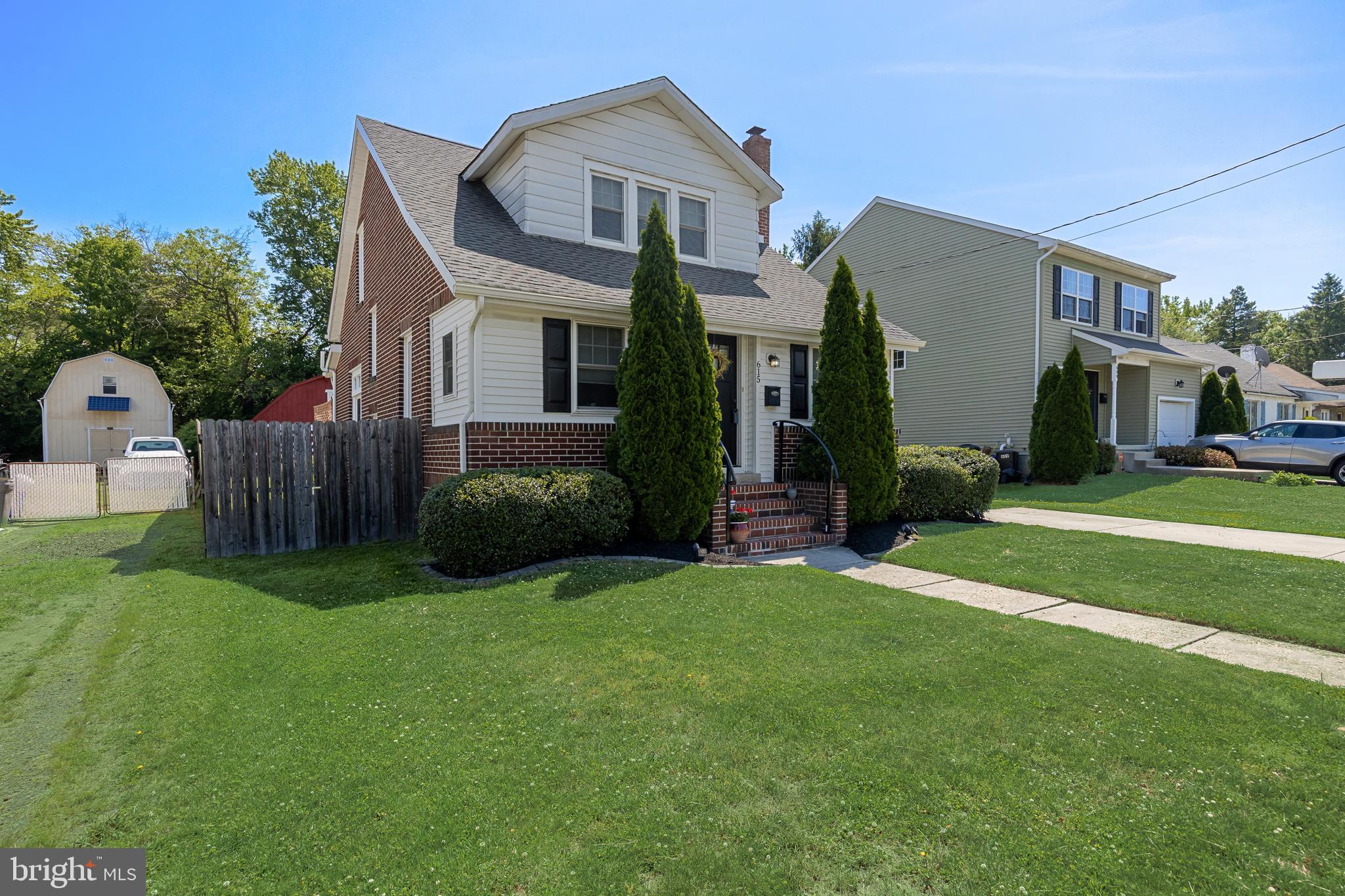 615 North Walnut Avenue Magnolia, NJ 08049 - Photo 2 of 40 a front view of a house with a yard and garage