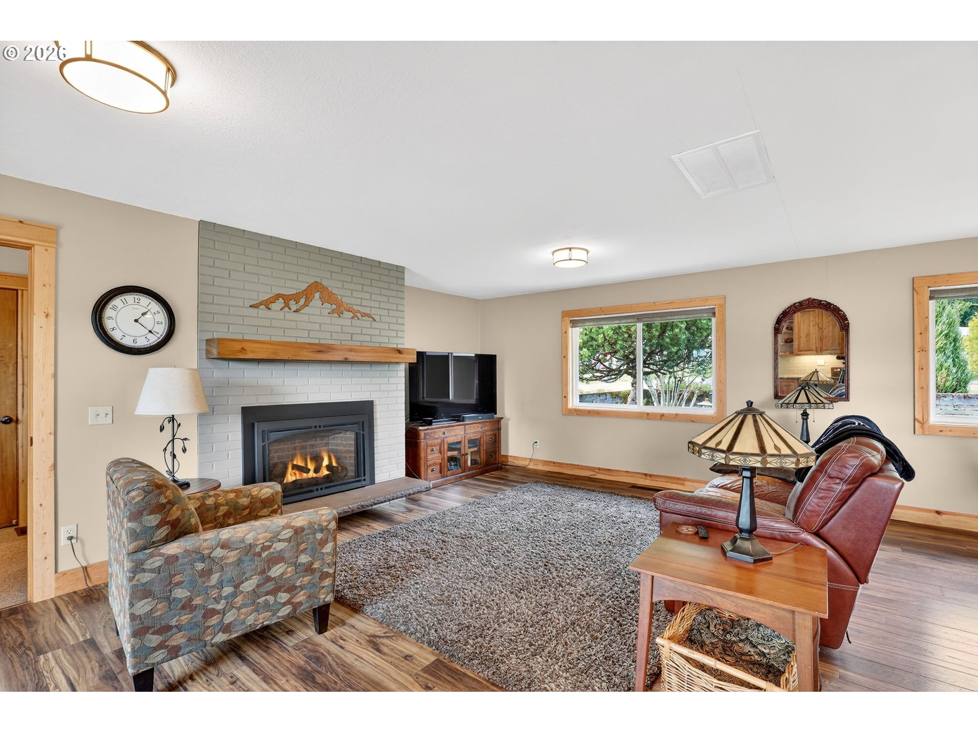 9732 Southeast Ladera Court Damascus, OR 97089 - Photo 12 of 41 a living room with furniture a window and a fireplace
