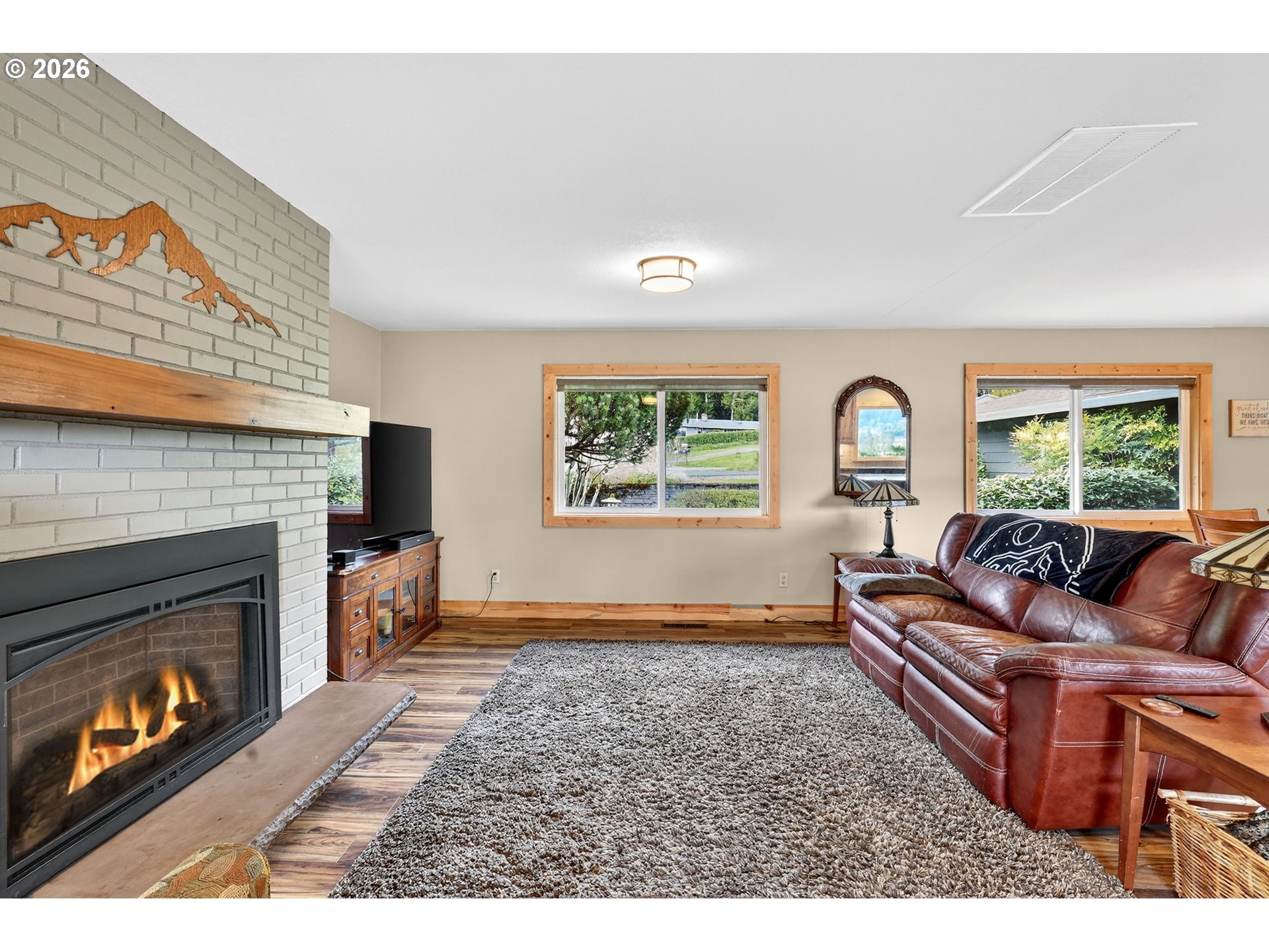 9732 Southeast Ladera Court Damascus, OR 97089 - Photo 14 of 41 a living room with furniture and a fireplace
