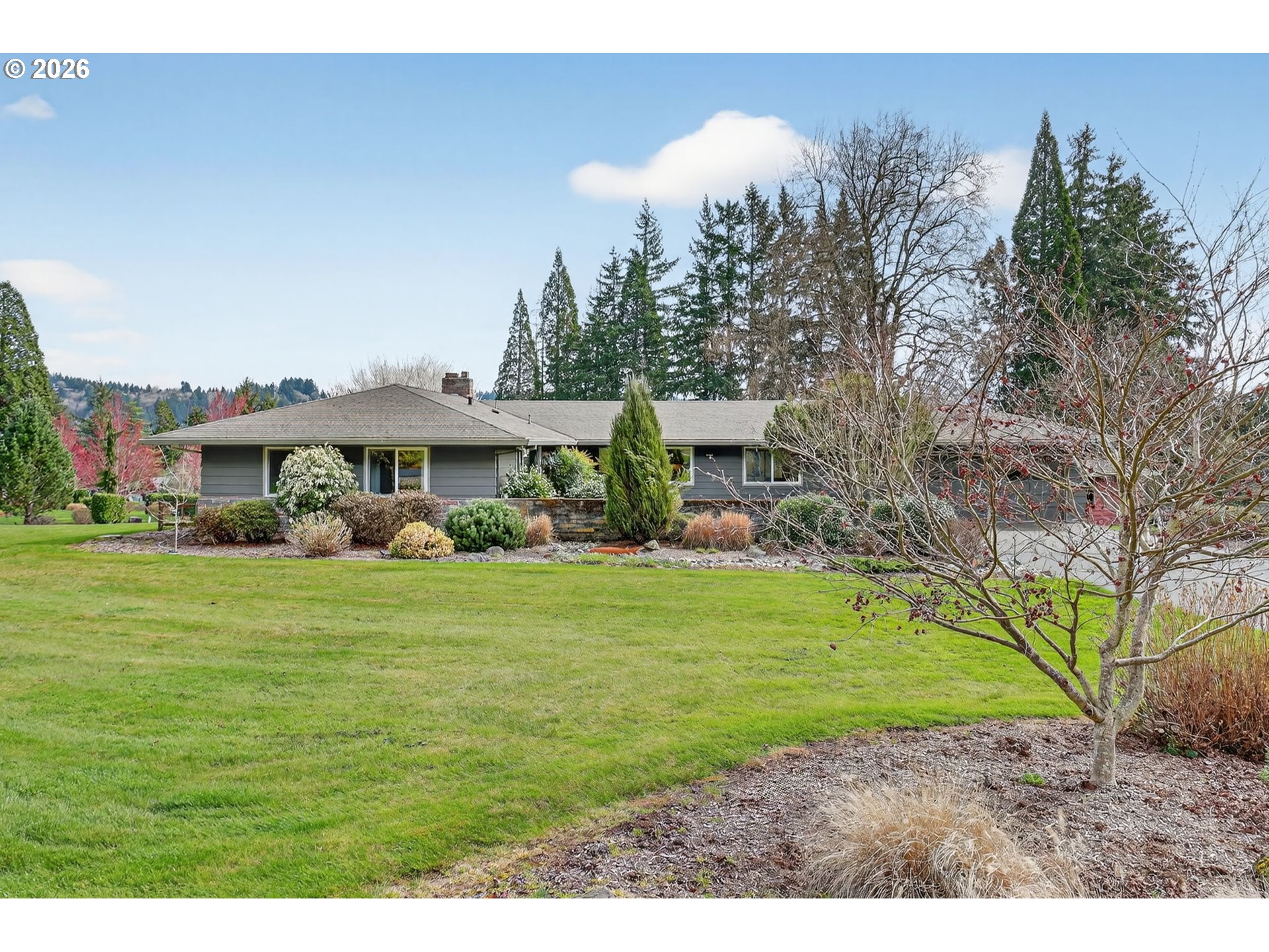 9732 Southeast Ladera Court Damascus, OR 97089 - Photo 3 of 41 a front view of a house with a garden