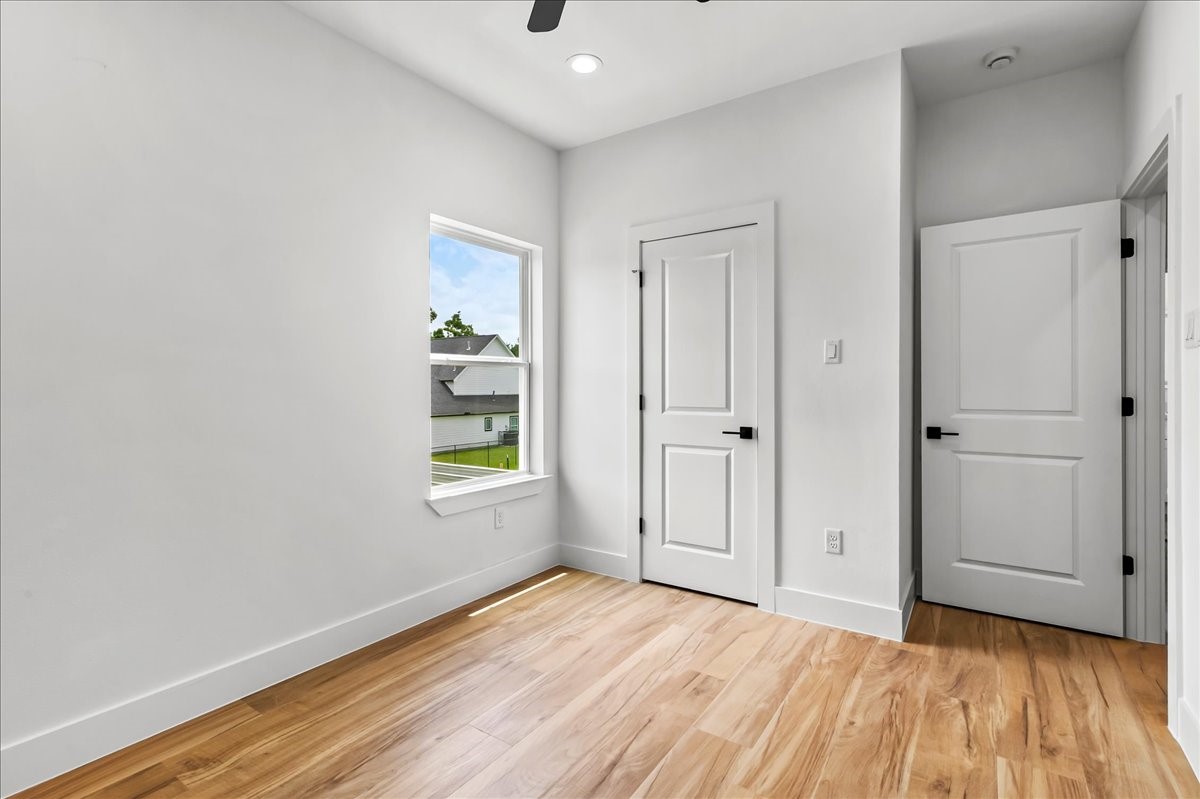 8323 Observatory Street, Unit A/B Houston, TX 77088 - Photo 29 of 38 Unit B - The secondary bedroom offers a bright and comfortable space with ample room for family, guests, or a home office.