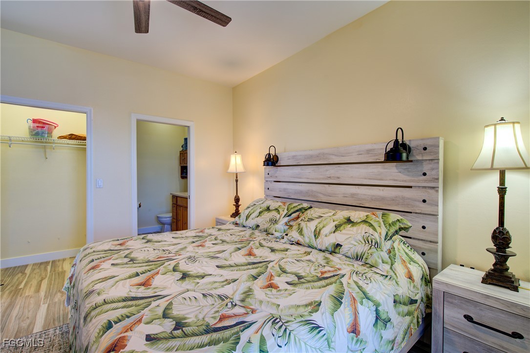 3184 Stringfellow Road St. James City, FL 33956 - Photo 17 of 46 a bedroom with a bed and a lamp on dresser