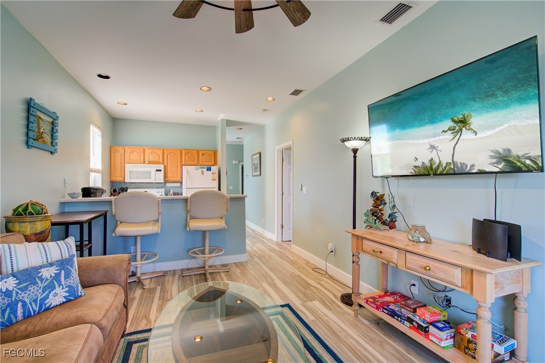 3184 Stringfellow Road St. James City, FL 33956 - Photo 18 of 46 a living room with furniture and wooden floor