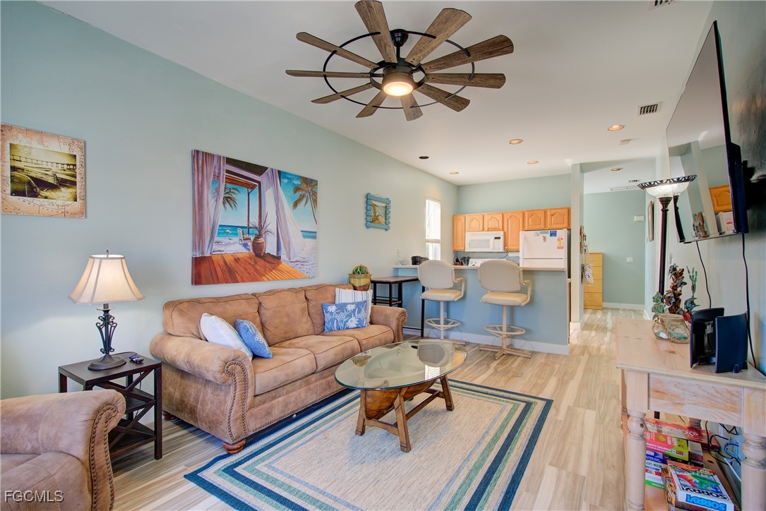 3184 Stringfellow Road St. James City, FL 33956 - Photo 19 of 46 a living room with furniture a flat screen tv and a table