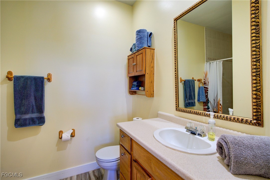 3184 Stringfellow Road St. James City, FL 33956 - Photo 28 of 46 a bathroom with a sink vanity mirror and toilet