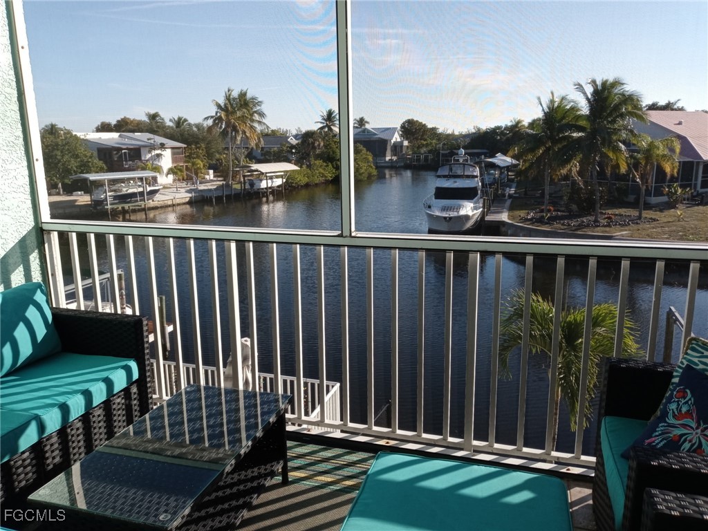3184 Stringfellow Road St. James City, FL 33956 - Photo 39 of 46 a view of a balcony with a floor to ceiling window and wooden fence