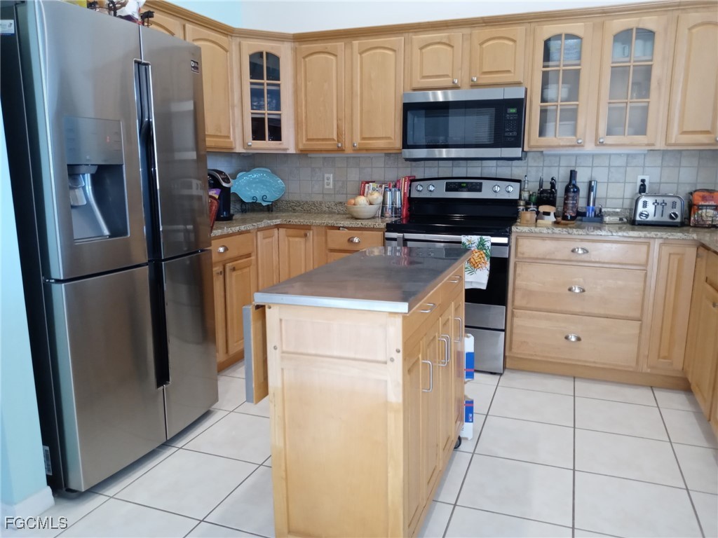3184 Stringfellow Road St. James City, FL 33956 - Photo 42 of 46 a kitchen with a refrigerator sink and microwave