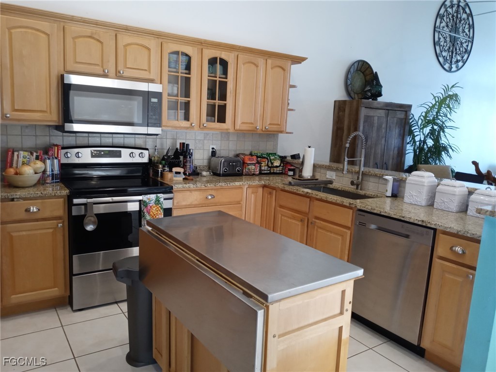 3184 Stringfellow Road St. James City, FL 33956 - Photo 44 of 46 a kitchen with a sink and a stove top oven