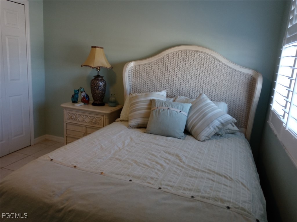 3184 Stringfellow Road St. James City, FL 33956 - Photo 45 of 46 a bedroom with a bed and window