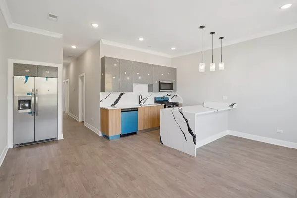 a kitchen with a sink a stove and a refrigerator