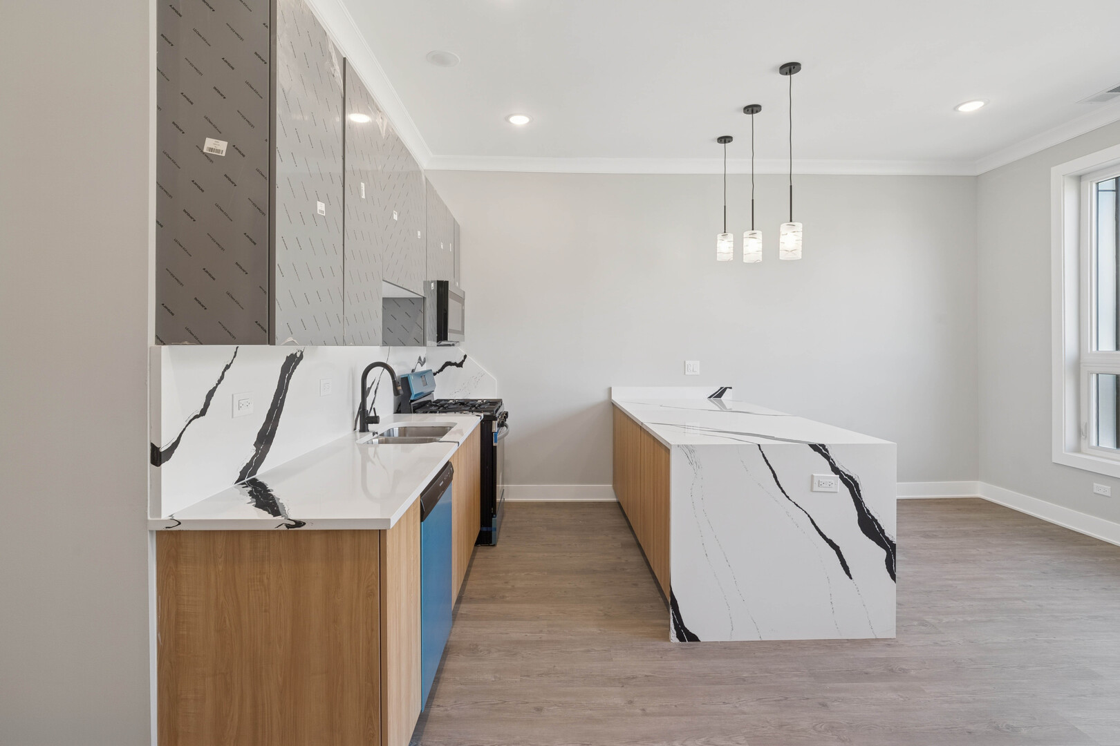 4839 West Huron Street, Unit 1 Chicago, IL 60644 - Photo 5 of 19 a kitchen with a sink a stove and a refrigerator
