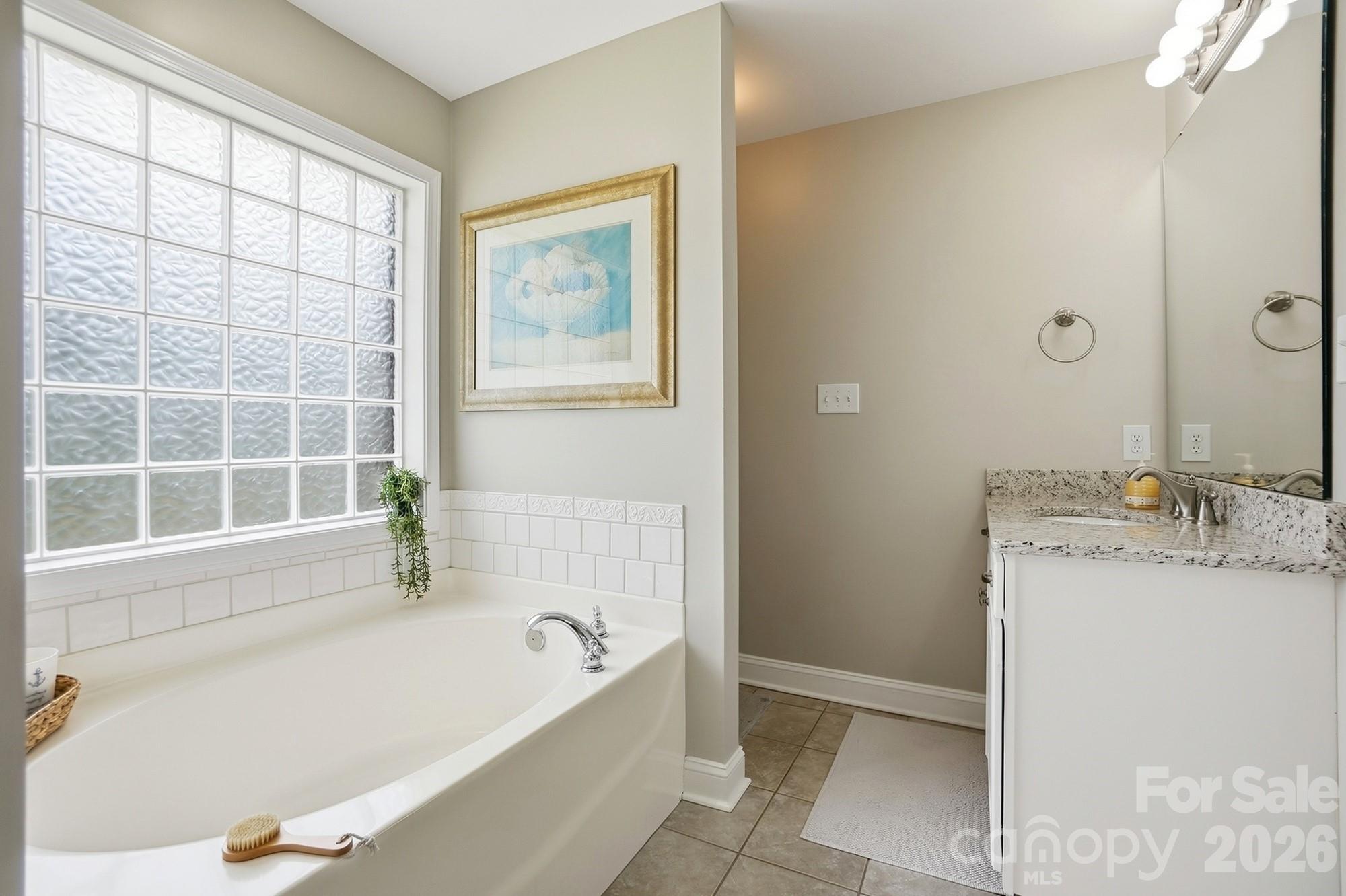 3324 Muddy Creek Road Midland, NC 28107 - Photo 31 of 46 a bathroom with a granite countertop tub sink and mirror