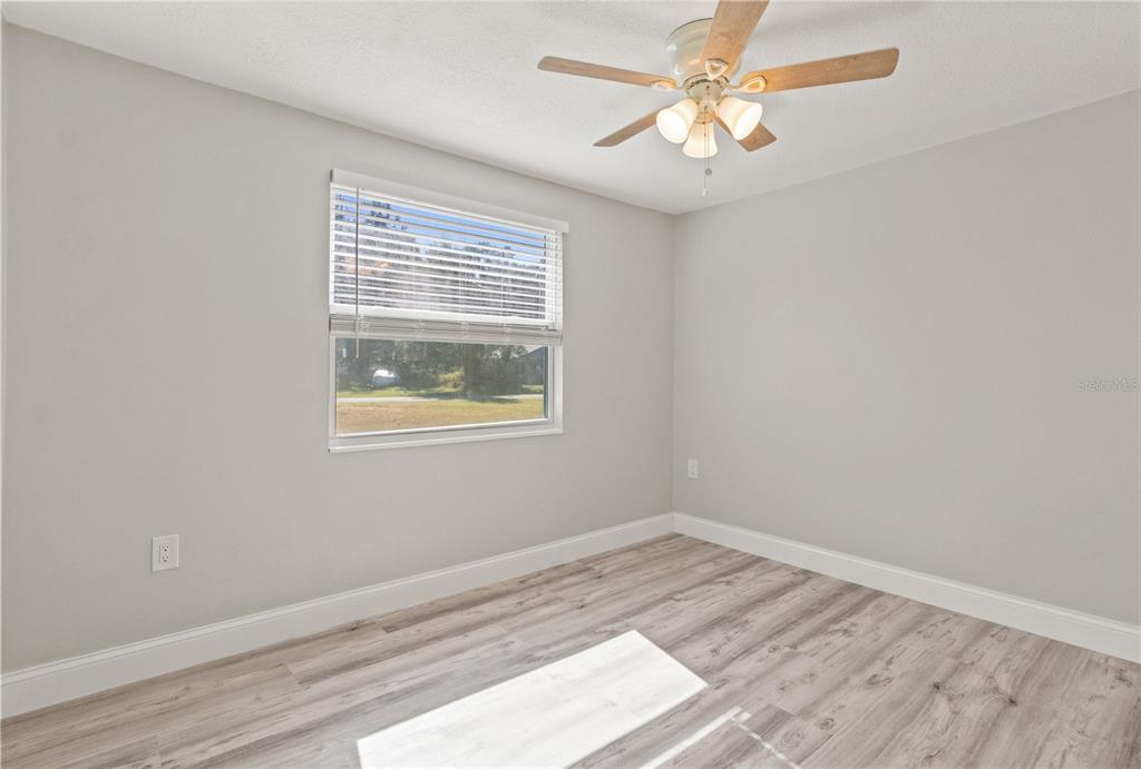 2716 Berdetta Street Leesburg, FL 34748 - Photo 17 of 35 a view of a room that has a window and wooden floor