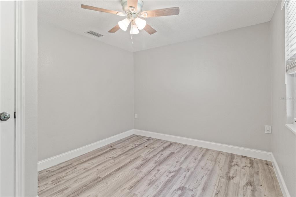 2716 Berdetta Street Leesburg, FL 34748 - Photo 27 of 35 wooden floor in a empty room