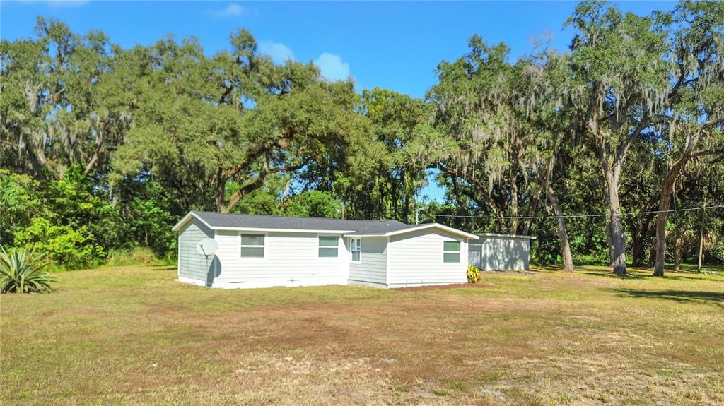 2716 Berdetta Street Leesburg, FL 34748 - Photo 34 of 35 a front view of house with yard and trees in the background