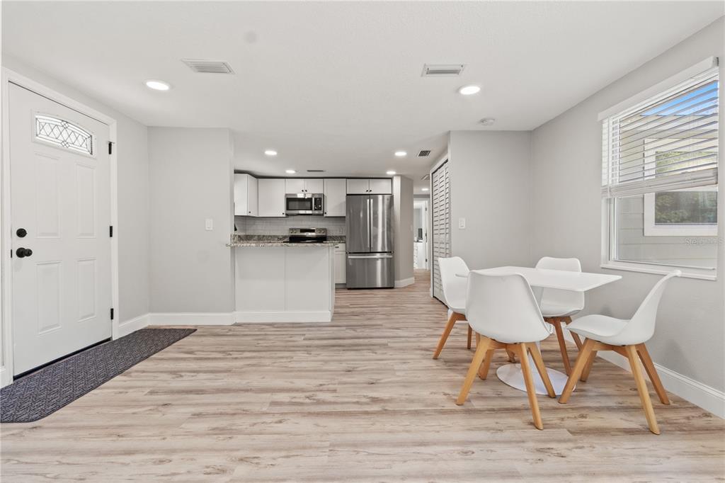2716 Berdetta Street Leesburg, FL 34748 - Photo 6 of 35 a view of kitchen and dining area with chandelier