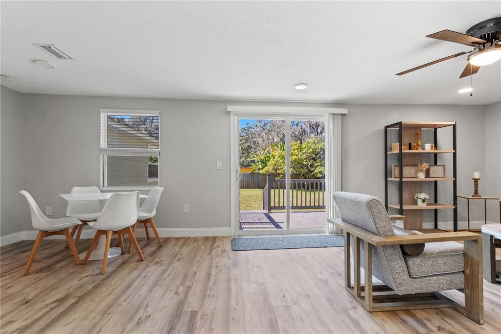 2716 Berdetta Street Leesburg, FL 34748 - Photo 9 of 35 a living room with furniture and a wooden floor