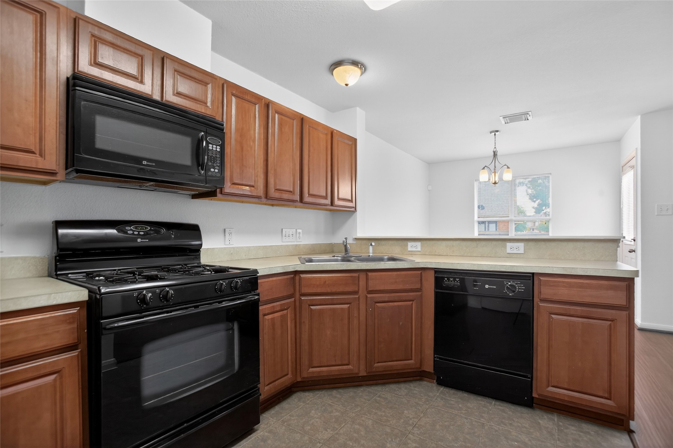 1618 Grable Cove Lane Spring, TX 77379 - Photo 12 of 32 Open-concept kitchen features abundant cabinet space, generous counters, and a seamless flow into the dining and living areas.