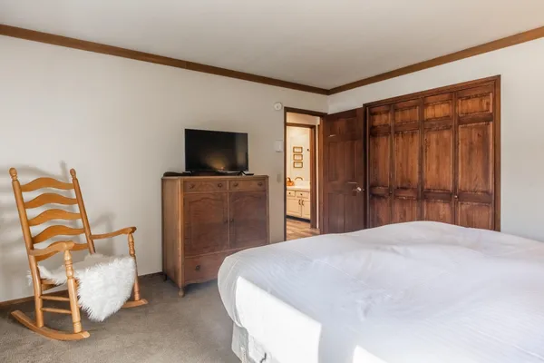 a bedroom with a bed and a flat screen tv