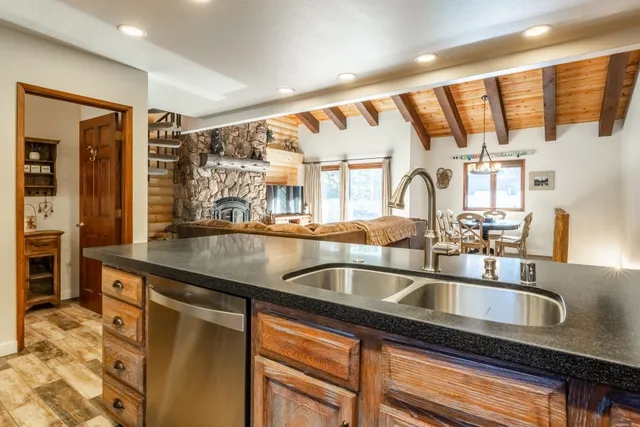 a kitchen with granite countertop a sink and a refrigerator