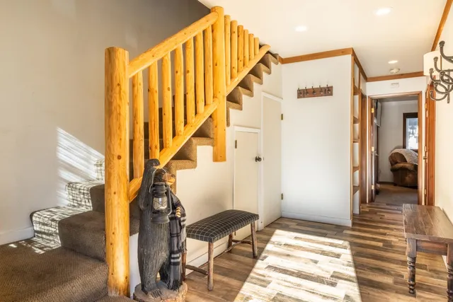 a view of entryway and hall with wooden floor