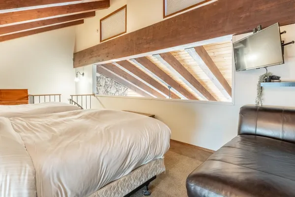 a bedroom with a bed and a night stand