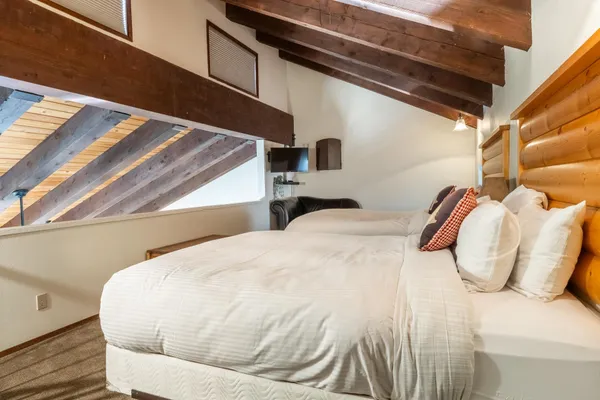 a bedroom with a bed and a painting on the wall