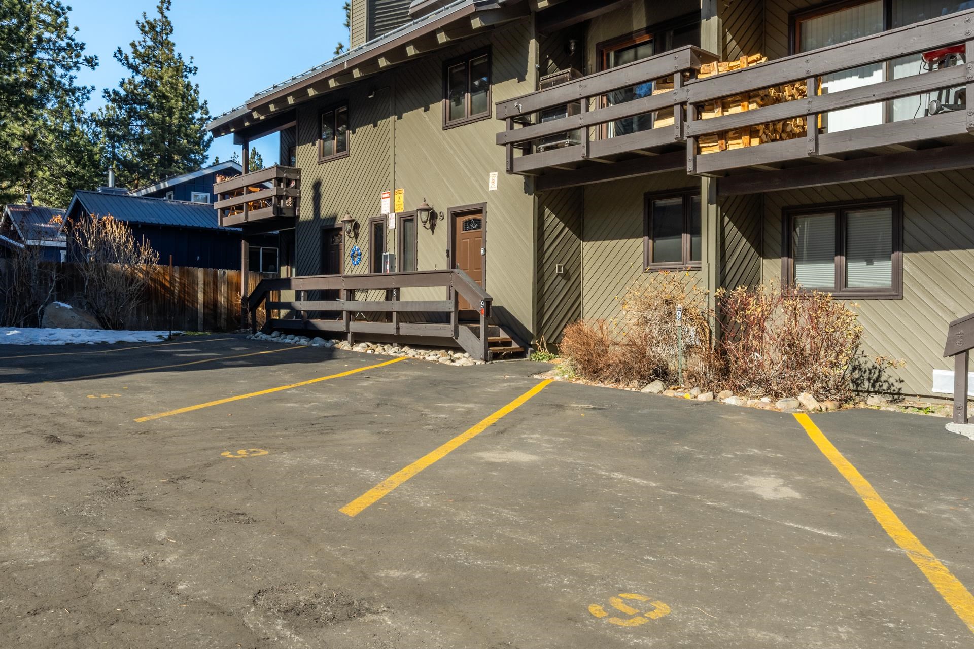 484 Manzanita Road, Unit 9 Mammoth Lakes, CA 93546 - Photo 34 of 39 a view of a patio with table and chairs under an umbrella with large trees