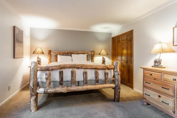 a bedroom with a bed and a table