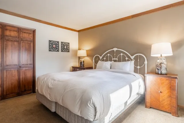 a bedroom with a bed and a lamp