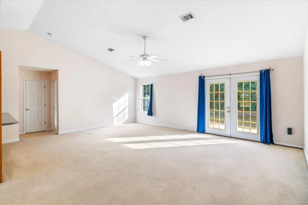 a view of a livingroom with a ceiling fan and window