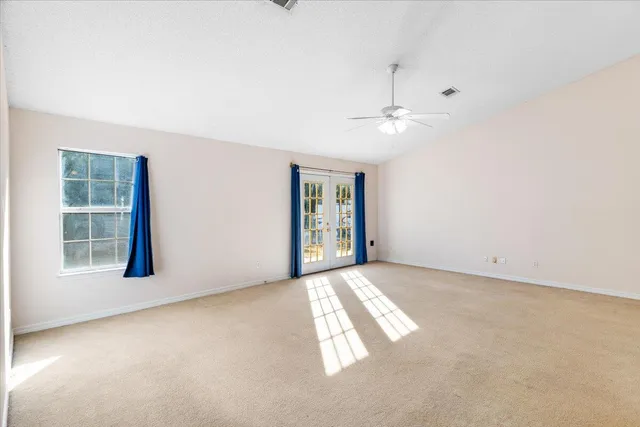 an empty room with windows and closet