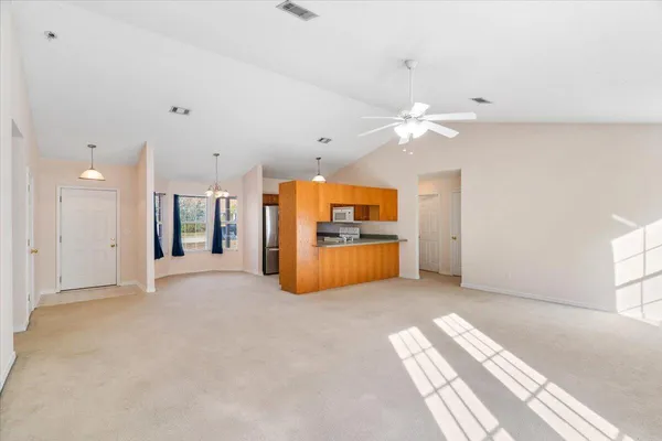 a view of a kitchen with a sink and a refrigerator