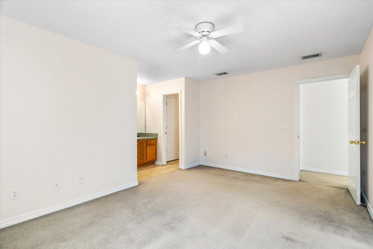 4640 Bobolink Way Crestview, FL 32539 - Photo 24 of 39 an empty room with a ceiling fan and a window