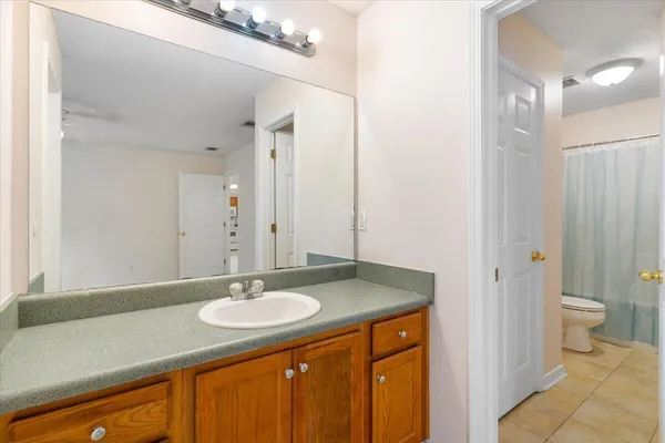a bathroom with a sink double vanity and a toilet