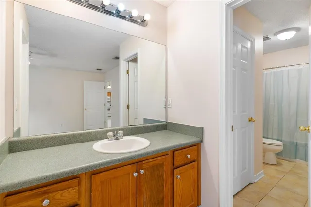 a bathroom with a sink double vanity and a toilet