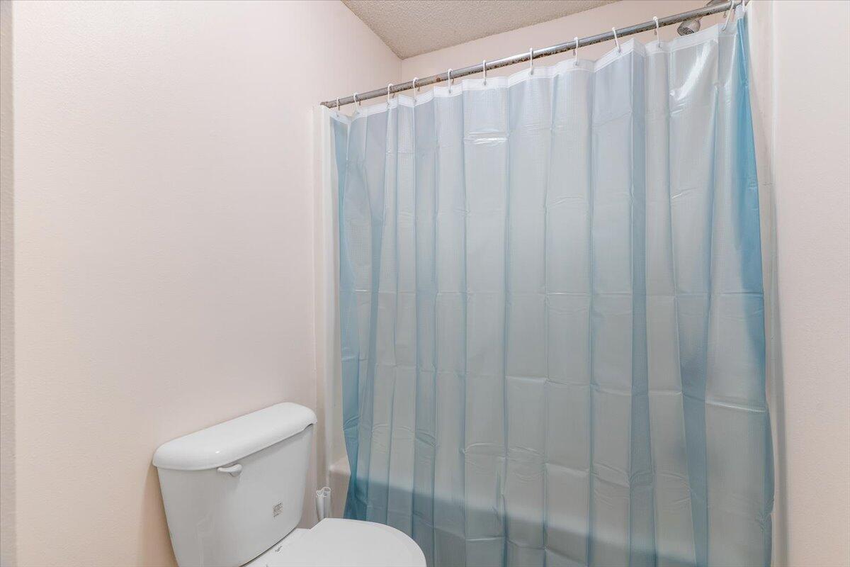 4640 Bobolink Way Crestview, FL 32539 - Photo 30 of 39 a white toilet sitting next to a shower