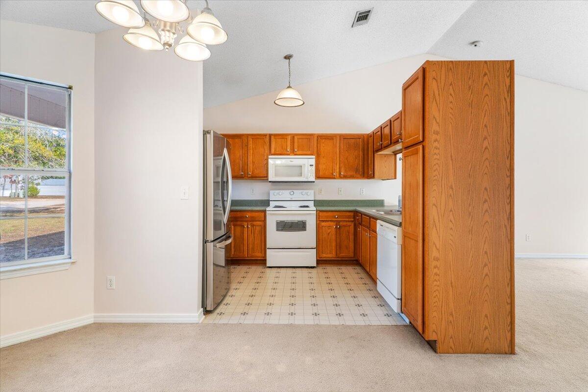 4640 Bobolink Way Crestview, FL 32539 - Photo 5 of 39 a kitchen with stainless steel appliances granite countertop a refrigerator a oven and a sink with granite countertops