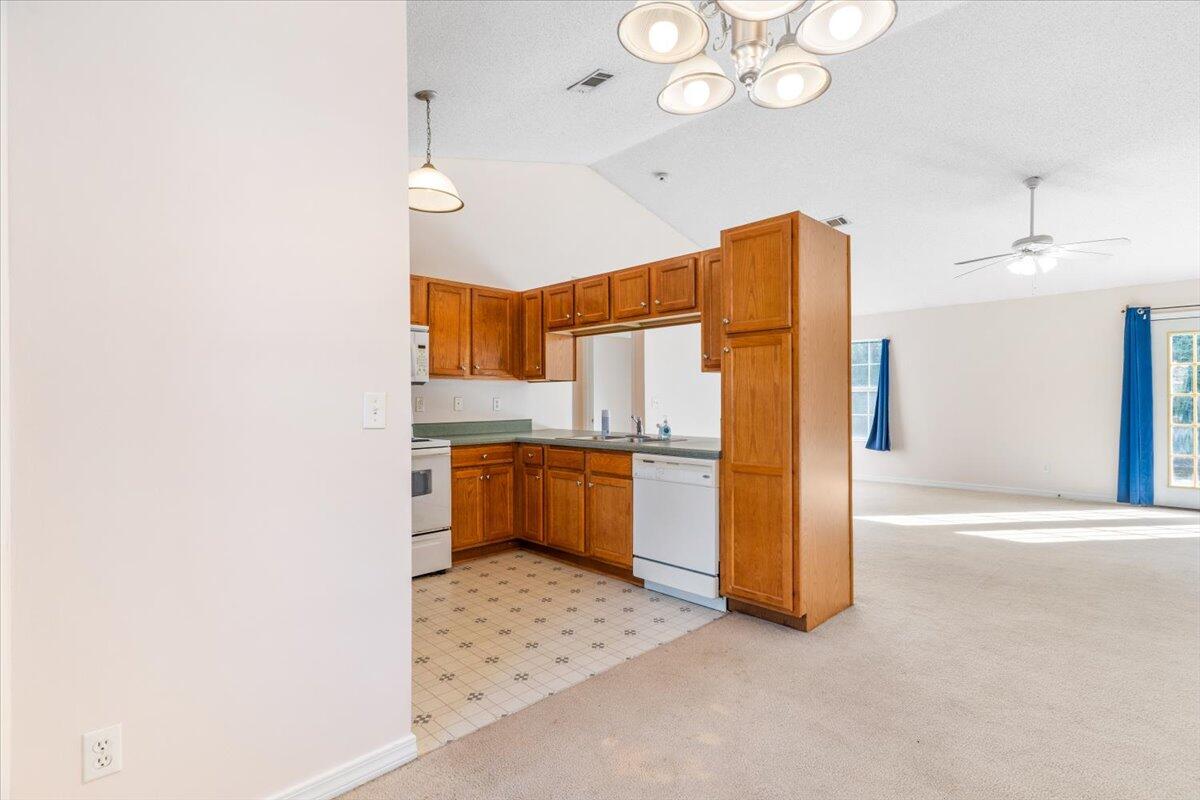 4640 Bobolink Way Crestview, FL 32539 - Photo 7 of 39 a kitchen with stainless steel appliances a refrigerator and cabinets