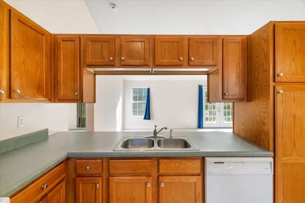 a kitchen with stainless steel appliances granite countertop a sink and cabinets