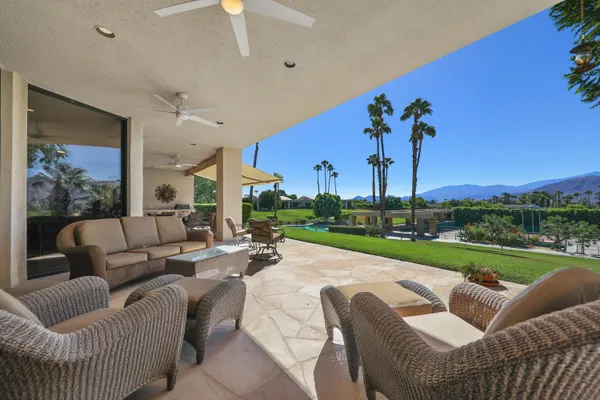 a living room with furniture and a garden