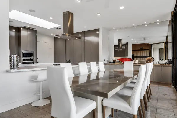a kitchen with kitchen island granite countertop a table and chairs