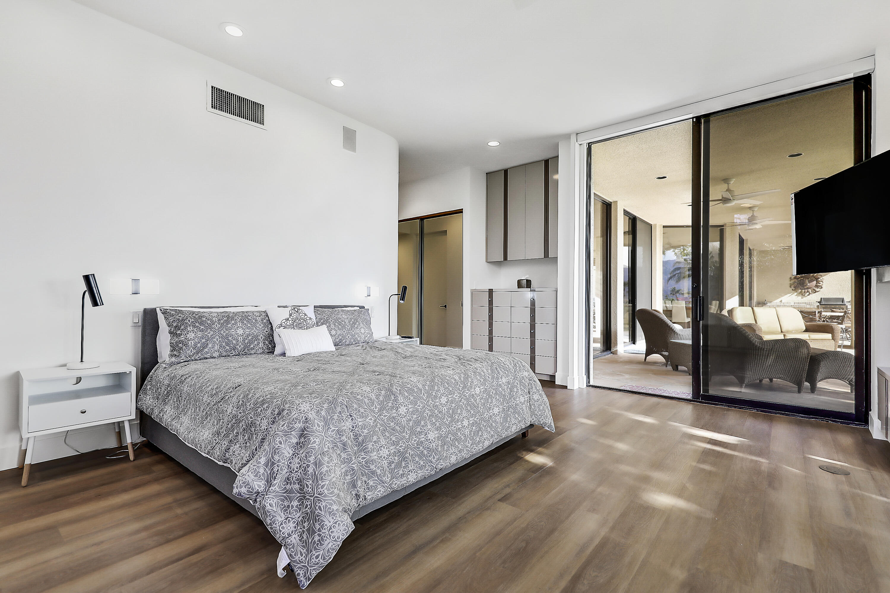 71000 Los Altos Court Rancho Mirage, CA 92270 - Photo 21 of 46 a spacious bedroom with a bed and a flat screen television